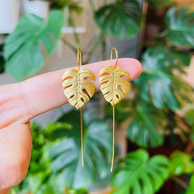 Shop Now Gold Monstera leaf earring.