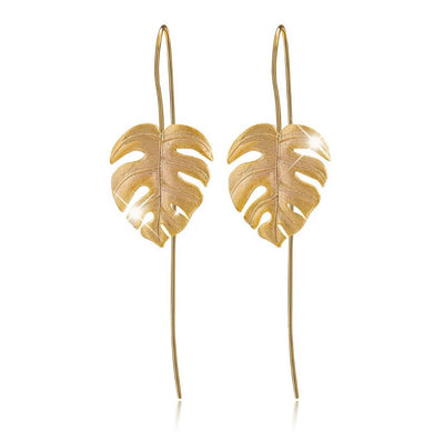 Shop Now Gold Monstera leaf earring.